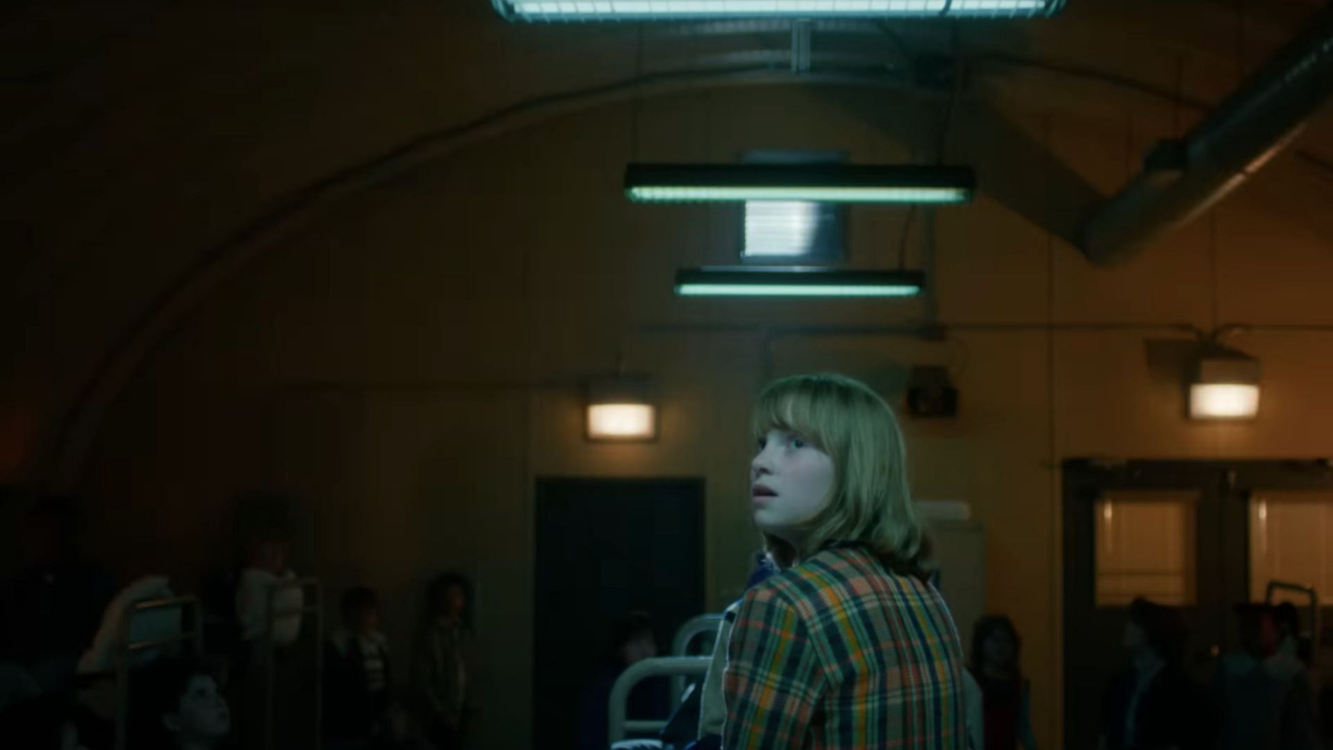 The residents of the town in Stranger Things are seen in a bunker (Image via YouTube/Netflix)